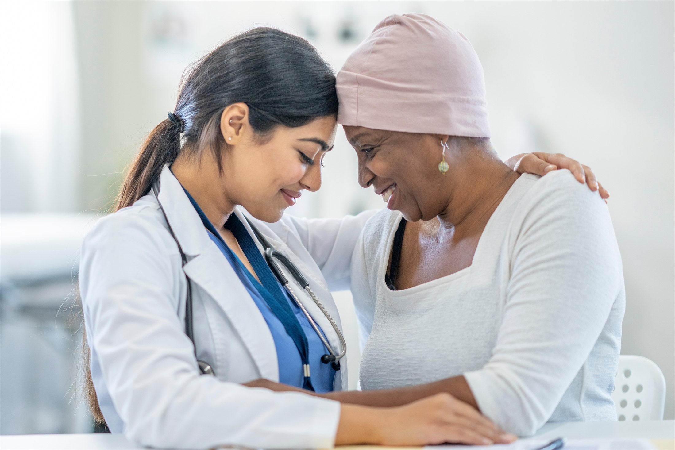 Clinician and patient sharing a calm supportive moment during cancer care